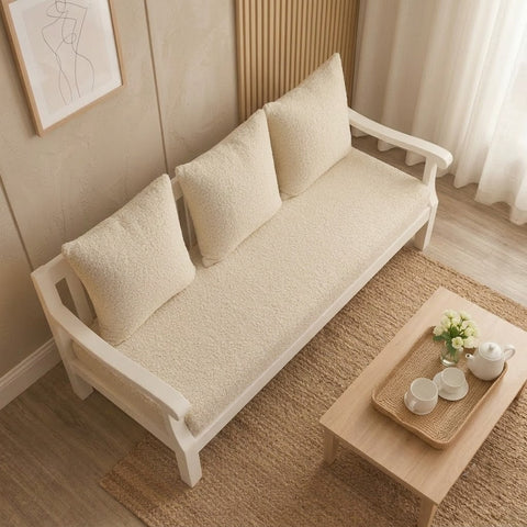 Close-up of soft crème boucle fabric upholstery on wooden sofa