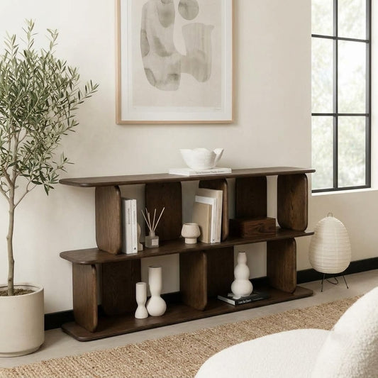 Dark wooden display shelf with sculptural rounded posts styled with books and ceramic vases
