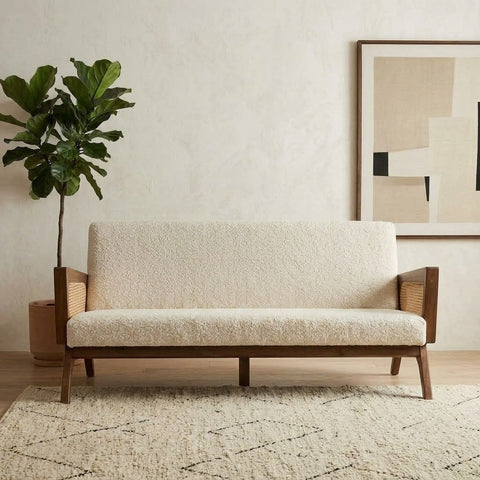 Handcrafted wooden sofa with cream boucle fabric and wicker detailing