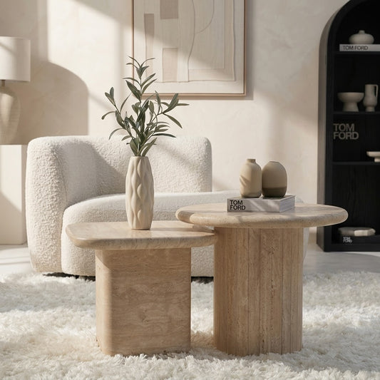 Round travertine coffee table nested beside square travertine table